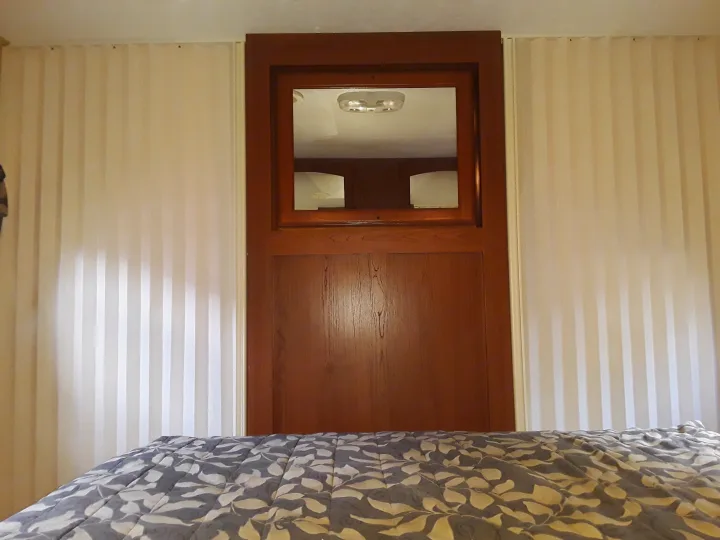 View from master bedroom with folding doors closed, mirror can be reversed to TV (either way). Keystone Outback BH312 2011