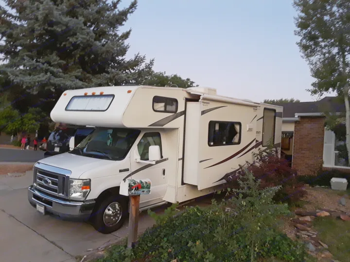 A white Class C RV rental, parked. Coachmen Freelander 2011