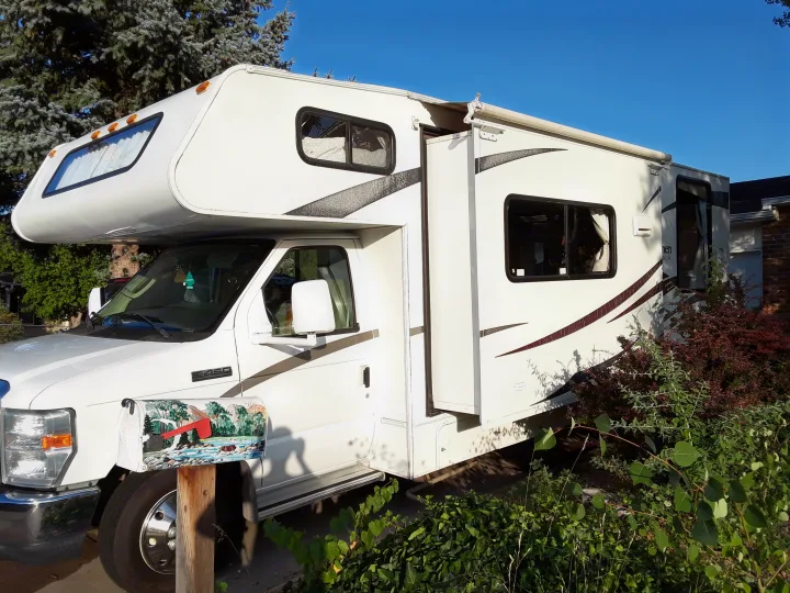White Class C RV rental parked. Coachmen Freelander 2011