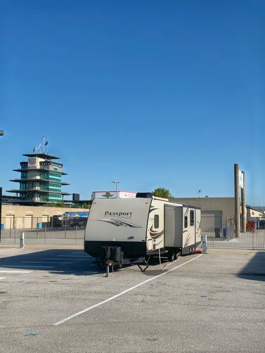 RV rental parked at Indianapolis Motor Speedway, iconic pagoda visible. Great for race fans!. Keystone Passport 2014