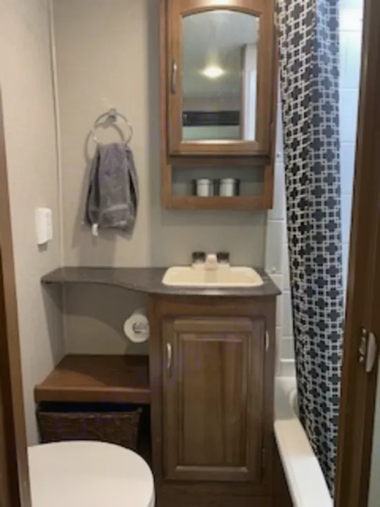 Inside an RV rental bathroom: vanity with sink, medicine cabinet, and toilet visible, ready for your road trip comfort.. Coachmen Freedom Express - Liberty Edition 2017
