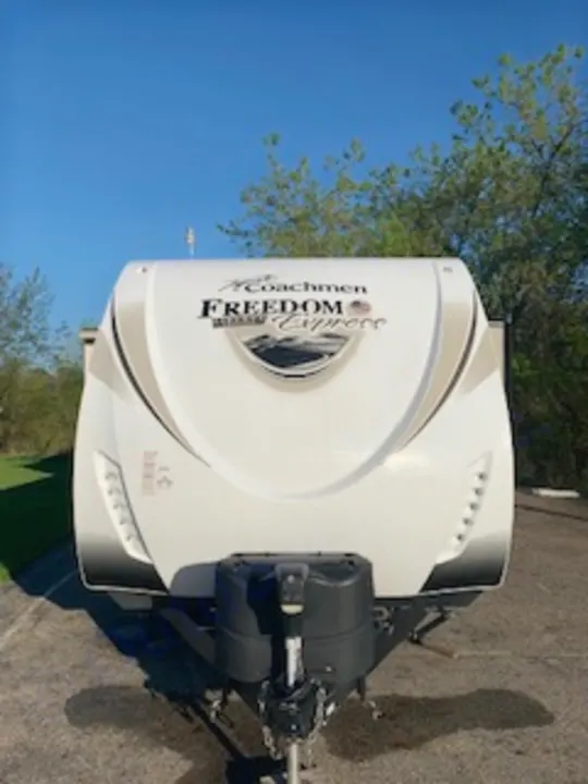 Front view of a white Coachmen Freedom Express travel trailer, an ideal RV for your next RV rental or camping getaway.. Coachmen Freedom Express - Liberty Edition 2017