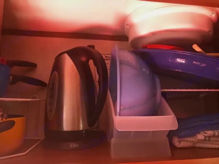 Compact RV rental kitchen storage with electric kettle, pots, bowls, & towels. Efficient use of space.. Jayco Jay Flight SLX 2017