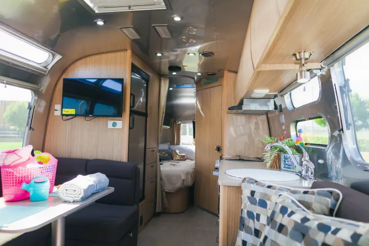 Bright RV rental interior showing living, kitchen, and bedroom areas.. Airstream Flying Cloud 2020