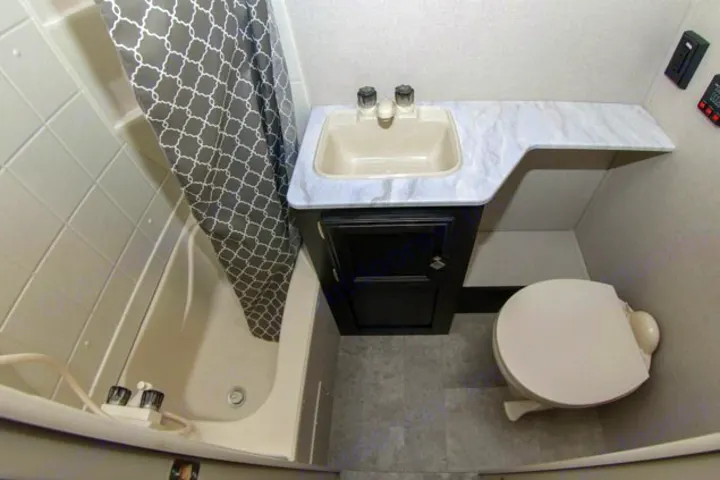 Clean and compact rv rental bathroom interior featuring a tub/shower, vanity sink, and toilet.. Venture Rv Sonic Lite SL 169VRD 2018