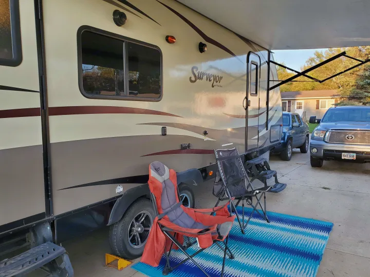 Awning plus outdoor speakers, area rug plus folding chairs. Forest River Surveyor 2015