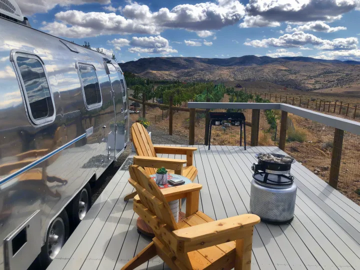 Sip a beverage on your private deck with Adirondack chairs and fire pit. Airstream Land Yacht 1977