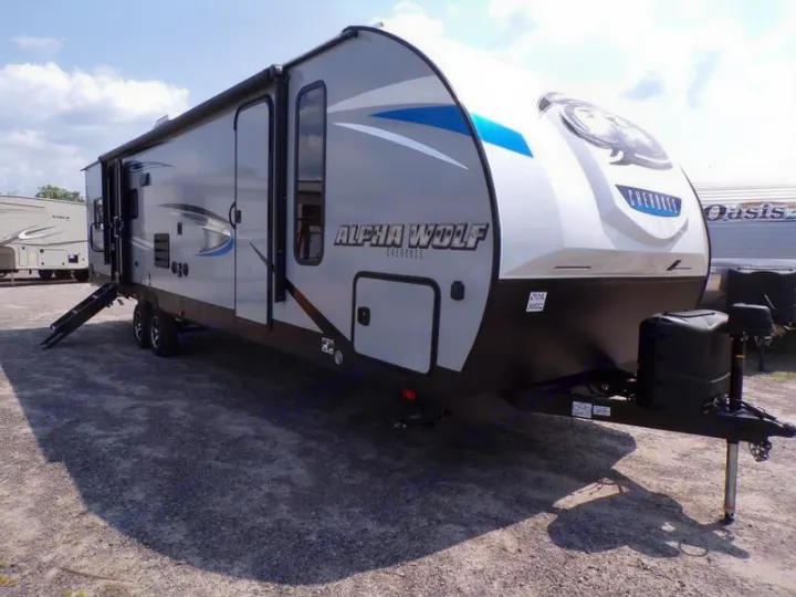 Modern gray Alpha Wolf Cherokee travel trailer with awning deployed, great for RV rental.. Forest River Alpha Wolf 2020