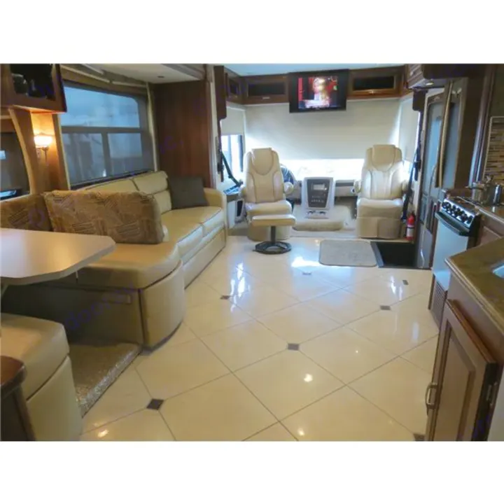 Inside this spacious RV rental: A bright RV interior with a sofa, dining area, kitchen, and front cockpit with TV.. Forest-River Georgetown 2014