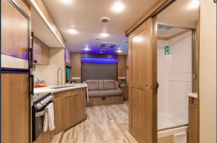 RV rental: Modern interior with full kitchen, versatile living space (sofa/bed), and private shower for ultimate comfort.. Grand Design Imagine XLS 19BWE 2020