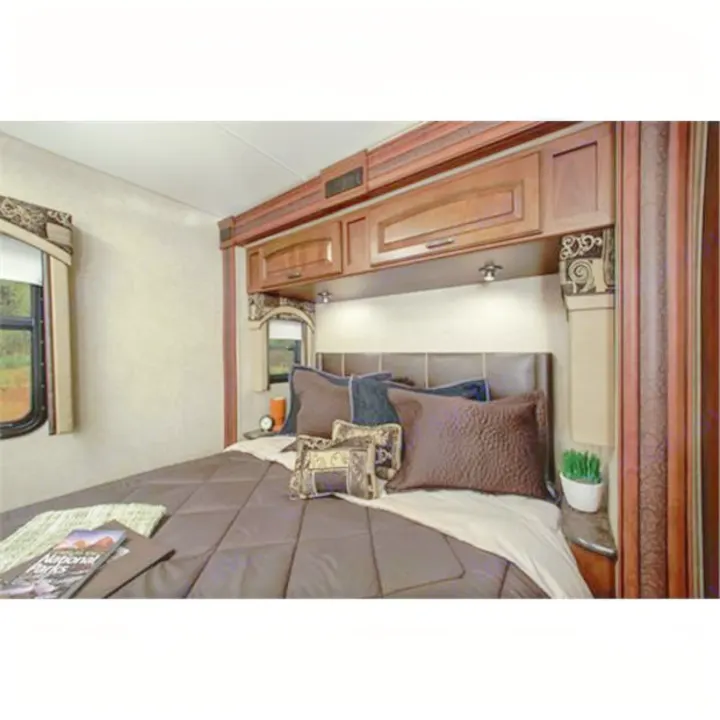 Cozy RV bedroom interior for your next RV rental adventure. Features a comfortable bed, overhead cabinets, and a window.. Jayco Precept 2014