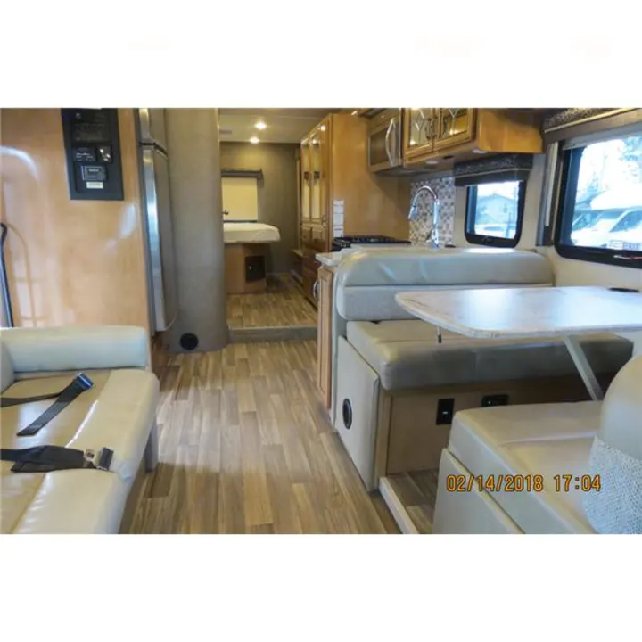 RV rental interior: Spacious living area with kitchen, dining booth, and rear bedroom for comfortable travel.. Thor Quantum 2017