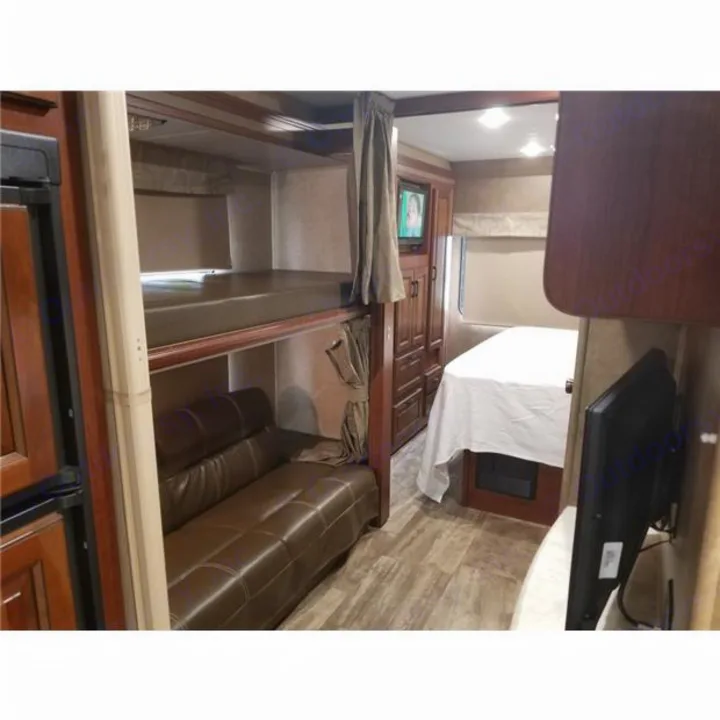 Spacious rv rental interior showing bunk beds, a convertible couch, dinette, and TV for comfortable travel.. Forest-River Forester 2017