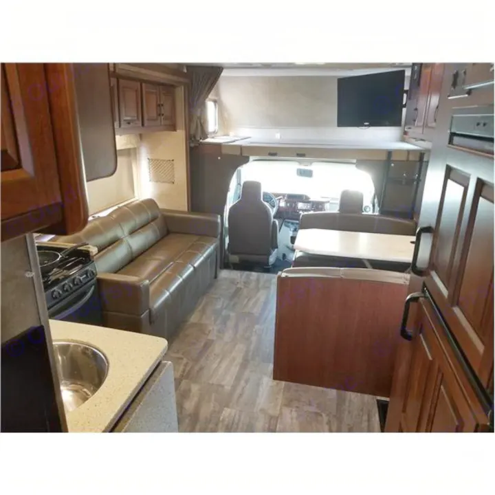 Spacious RV rental interior with kitchen, sofa, dining booth, and overhead bunk with TV.. Forest-River Forester 2017