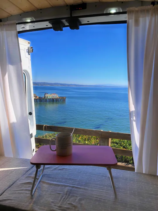 Perfect RV rental morning: panoramic ocean view with a pier, enjoyed with coffee from your comfortable bed.. Ford Transit 2015