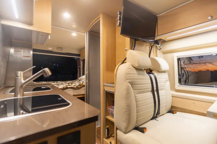 Step inside this modern RV rental: a compact home on wheels with kitchen, living, and bed areas.. Hymer Other 2019