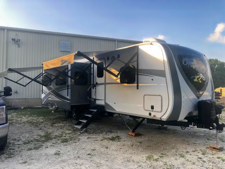 Exterior passenger side with one slide and awnings out.. Open Range Open Range 2019