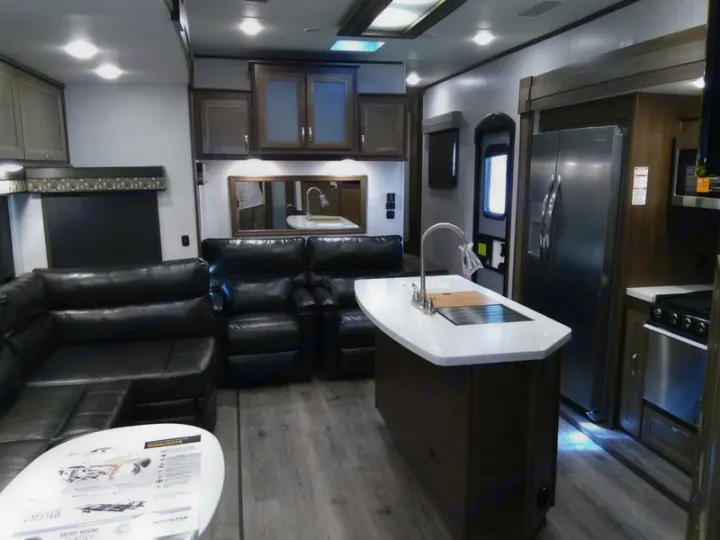Spacious luxury RV rental interior: living area with leather seating, island kitchen, and modern amenities.. Highland Ridge Mesa Ridge 427BHS 2019