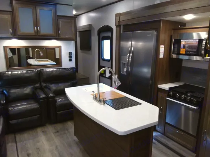 Modern RV rental interior: full kitchen with island and appliances, plus comfortable recliners.. Highland Ridge Mesa Ridge 427BHS 2019