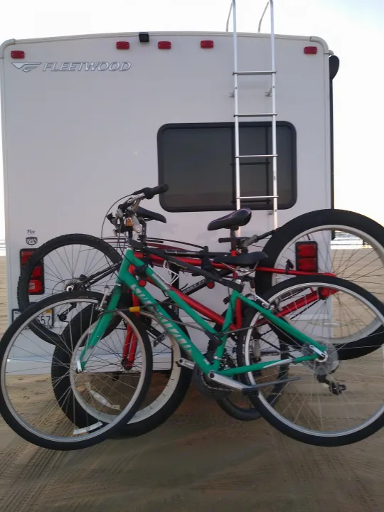 Fleetwood RV rental loaded with bikes on a rack, parked on sand.. Fleetwood Other 2018