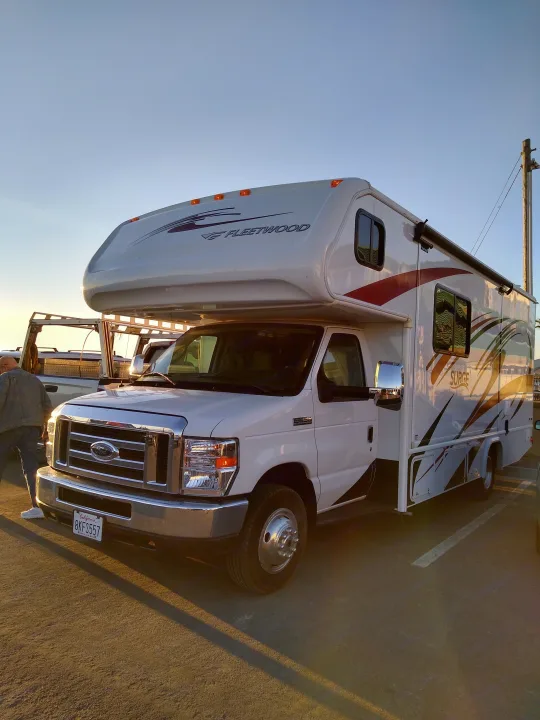White Fleetwood Surge RV rental, a Ford Class C motorhome, shines at sunset. Perfect for your next adventure.. Fleetwood Other 2018