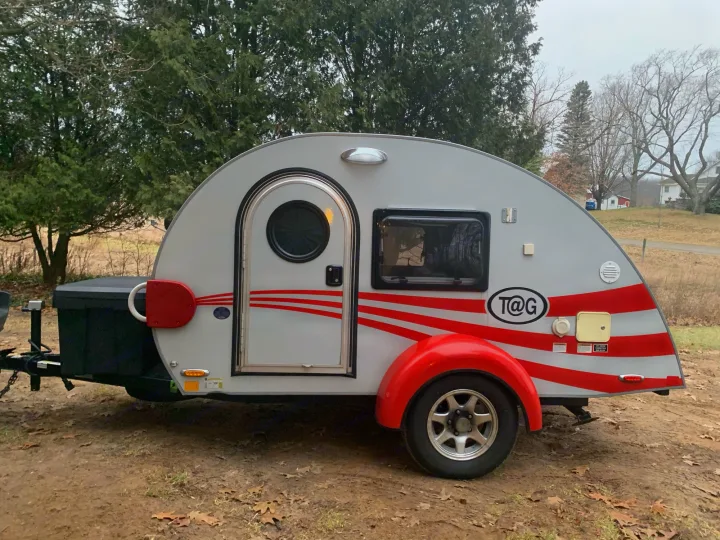 This grey T@G teardrop travel trailer, with red accents, is an excellent rv rental for outdoor adventures and camping.. T@G T@G Trailer 2016