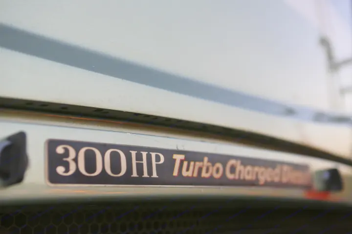 Close-up of an RV rental's "300HP Turbo Charged Diesel" badge, detailing the powerful engine.. Coachmen Cross Country 2005