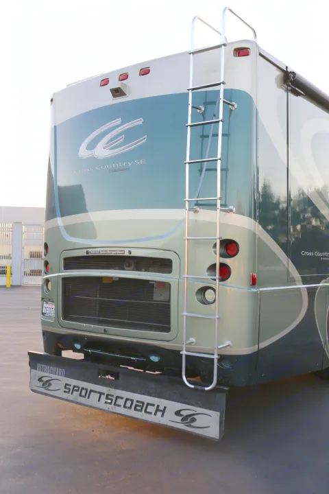 Rear of a Sportscoach Cross Country SE RV, featuring a ladder and powerful diesel engine, ideal for rv rental travel.. Coachmen Cross Country 2005