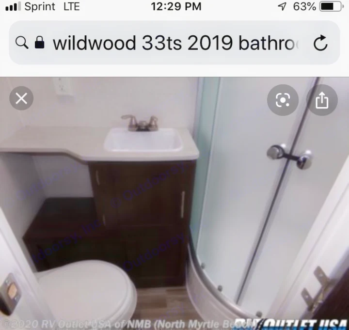 Bathroom with wrap-around shower. . Wildwood 32qbss 33ts 2019