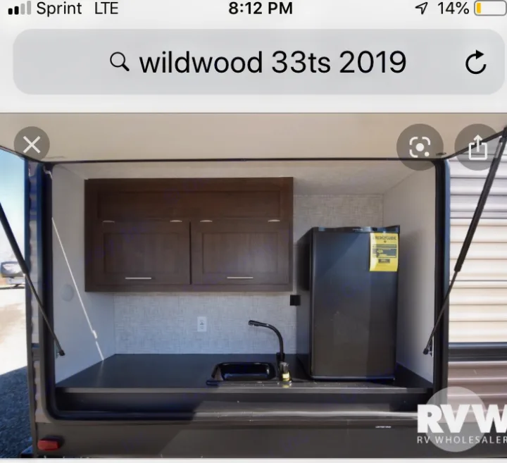 Outdoor Kitchen with refrigerator, sink, and extra storage . Wildwood 32qbss 33ts 2019