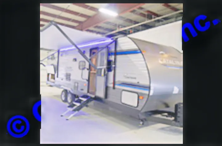 This modern silver travel trailer, with its extended awning and blue LED lights, is ready for your RV rental adventure.. Coachmen Catalina 2019