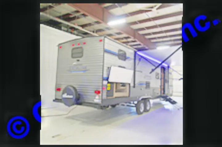 Gray travel trailer with an outdoor kitchen, extended awning & blue lights – perfect for your next RV rental trip!. Coachmen Catalina 2019