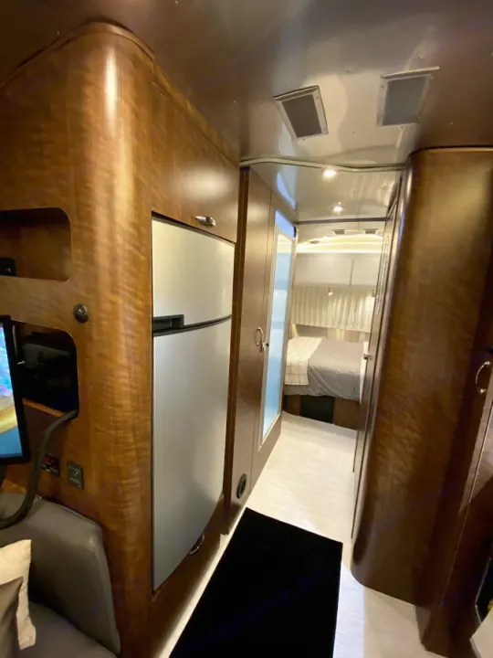 RV rental interior: A narrow hallway leading from the compact kitchen & living area to a cozy bedroom.. Airstream Globetrotter 2020