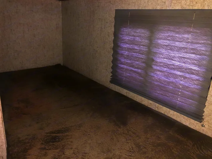 Interior view of an RV rental bunk bed. Features soft dark bedding, textured walls, and pleated window blinds.. Coachmen Apex Nano 2019