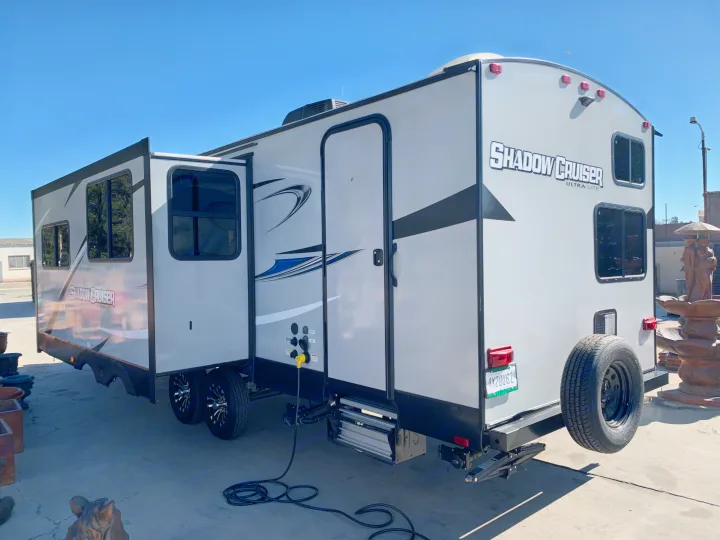 Explore with this Shadow Cruiser RV rental! A gray travel trailer with extended slide-out, ready for adventure.. Cruiser Rv Corp Shadow Cruiser 2019