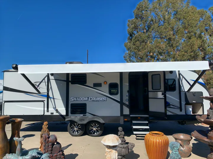 Shadow Cruiser RV rental: a modern gray travel trailer with extended awning & open door, ready for your outdoor adventure.. Cruiser Rv Corp Shadow Cruiser 2019