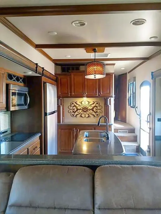 Spacious RV rental interior featuring a full kitchen with modern appliances, ample storage, and comfortable living area.. Heartland Big Country 2016