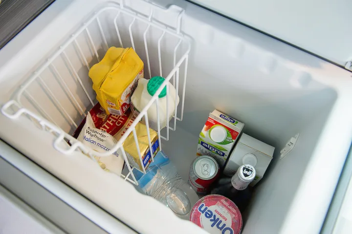An RV rental fridge/cooler stocked with milk, mozzarella, almond milk, and drinks, ready for your road trip adventure.. Volkswagen California Ocean 2024