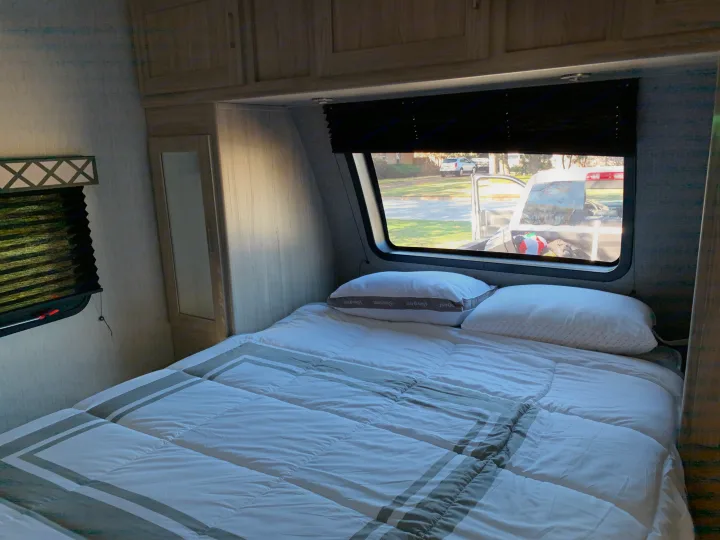 Queen size bed and a big window adds lots of light . Coachmen Freedom Express 2020