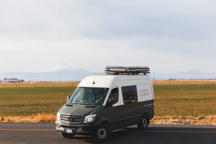 Honest Camper Mercedes Sprinter rv rental van, two-tone, parked by fields & snow-capped mountains for your next adventure.. Mercedes-Benz Sprinter 2017