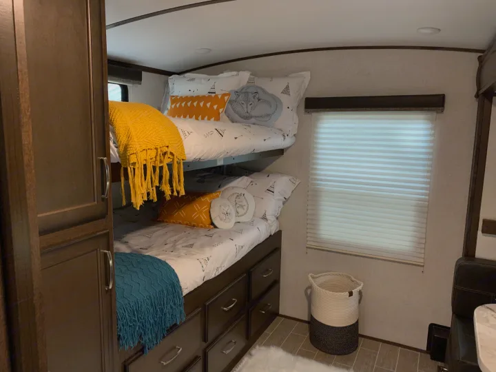 *Bunk Room*
This view shows 2 3/4 full bunk beds. Other side of bedroom has a single bunk, and a small dinette that turns into a single bed. This room comes with a ton of storage!. Dutchmen Atlas 3202BH 2020