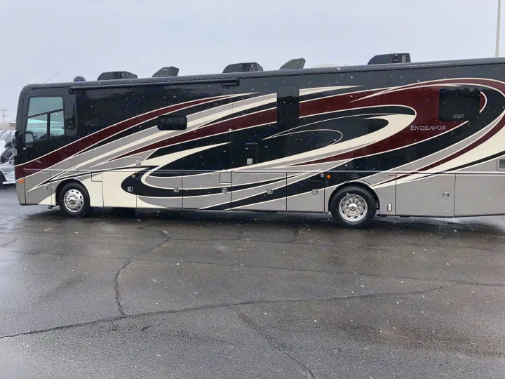 Experience winter travel! This black & grey Endeavor RV motorhome is ready for your rv rental. Light snow.. Holiday Rambler Endeavor 2018
