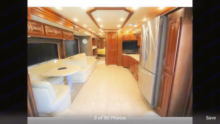 Spacious RV rental features a luxury interior with full kitchen, cream seating, and wood cabinets for comfort.. Holiday Rambler Endeavor 2018