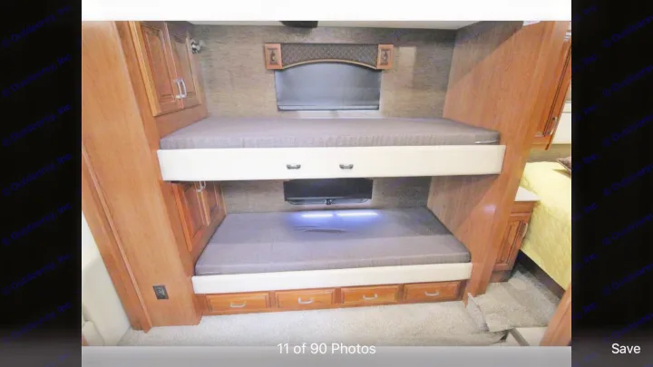 RV rental featuring comfortable bunk beds with built-in TVs and drawers, ideal for family sleeping and storage.. Holiday Rambler Endeavor 2018