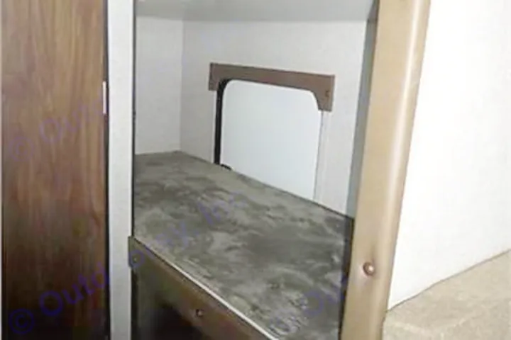 RV rental: Interior view of a bunk bed with a dark mattress and window, a cozy sleeping space in a camper.. Forest River Cherokee Wolf Pup 2019
