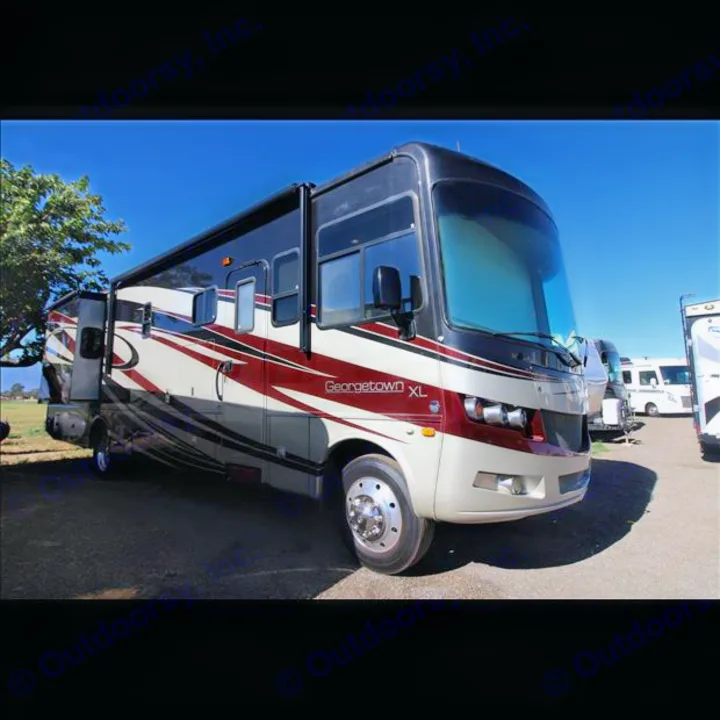 Georgetown XL Class A motorhome for rv rental, with slide-outs extended, parked in a sunny outdoor lot.. Forest River Georgetown 2013