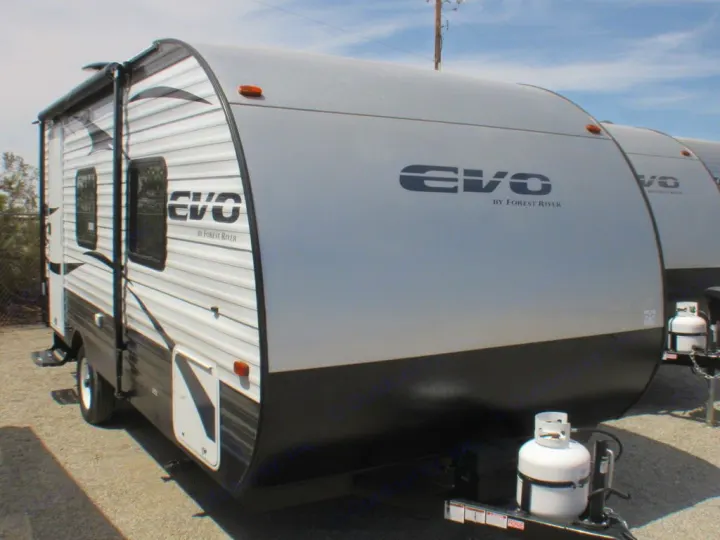 This grey and black EVO travel trailer, with propane tanks, is an excellent option for RV rental.. Forest River Evo 2019