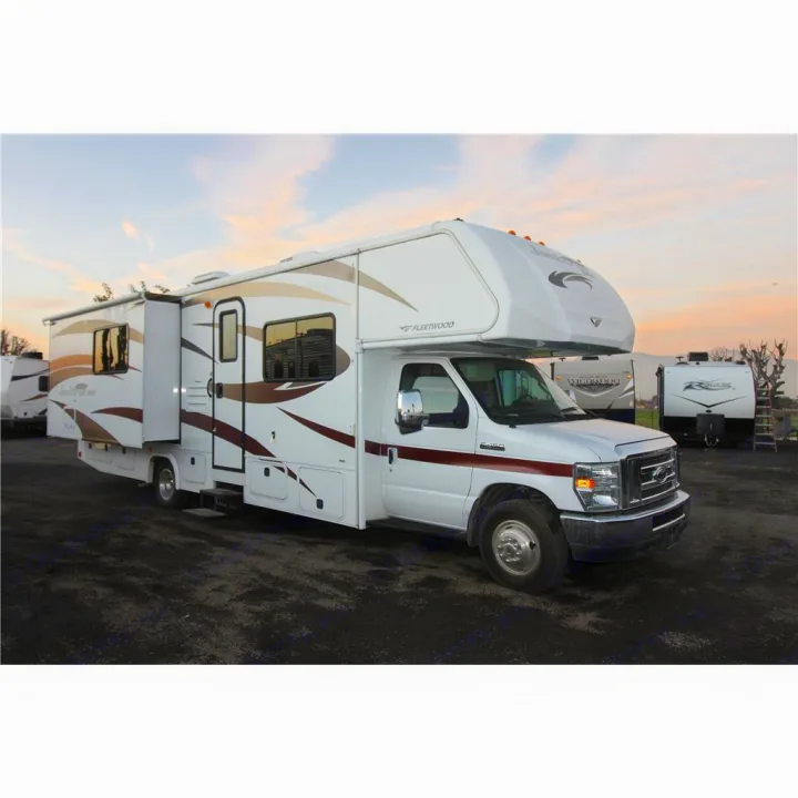 White Class C Fleetwood RV rental with extended slide-out, parked on a lot at sunset, ready for your next adventure.. Fleetwood Jamboree Sport 2014