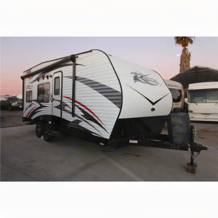 Experience freedom with this white and black travel trailer, featuring sporty graphics, ready for your RV rental adventure.. Pacific Coachworks Rage'N 2016