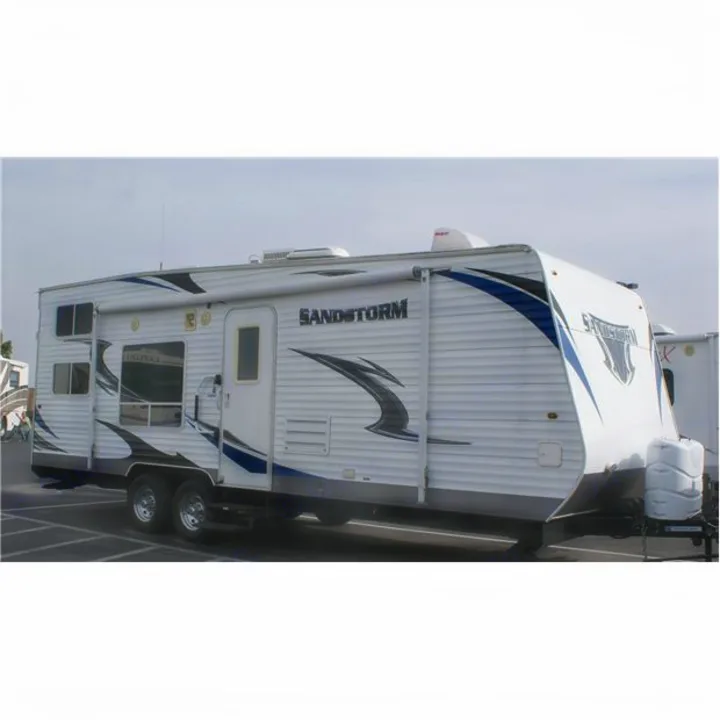 White Sandstorm travel trailer RV rental, featuring blue/black graphics. Perfect for camping and outdoor adventures.. Forest River Sandstorm 2013